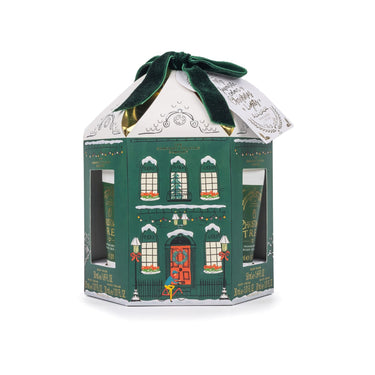 Hexagonal green gift box with a white roof and red door on a white background