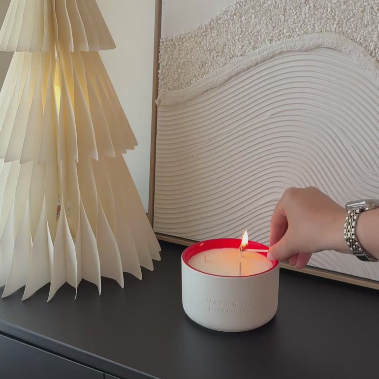 lighting a pomegranate christmas candle