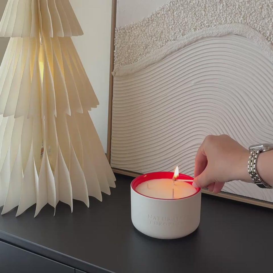 lighting a pomegranate christmas candle